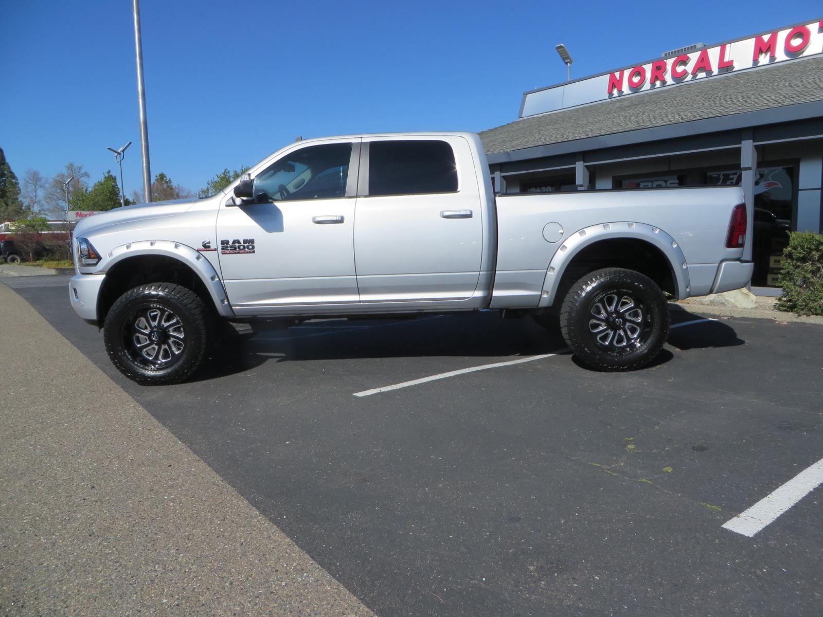 2016 SILVER /BLACK RAM 2500 Laramie Crew Cab SWB 4WD (3C6UR5FL3GG) with an 6.7L L6 OHV 24V TURBO DIESEL engine, 6A transmission, located at 2630 Grass Valley Highway, Auburn, CA, 95603, (530) 508-5100, 38.937893, -121.095482 - Leveled Ram sitting on Fuel Offroad wheels, Falken Wildpeak AT tires, Amp Power steps, Rolling Bed cover, Color matched fender flares, and window tint. - Photo #7